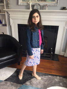 child shows the skirt she made